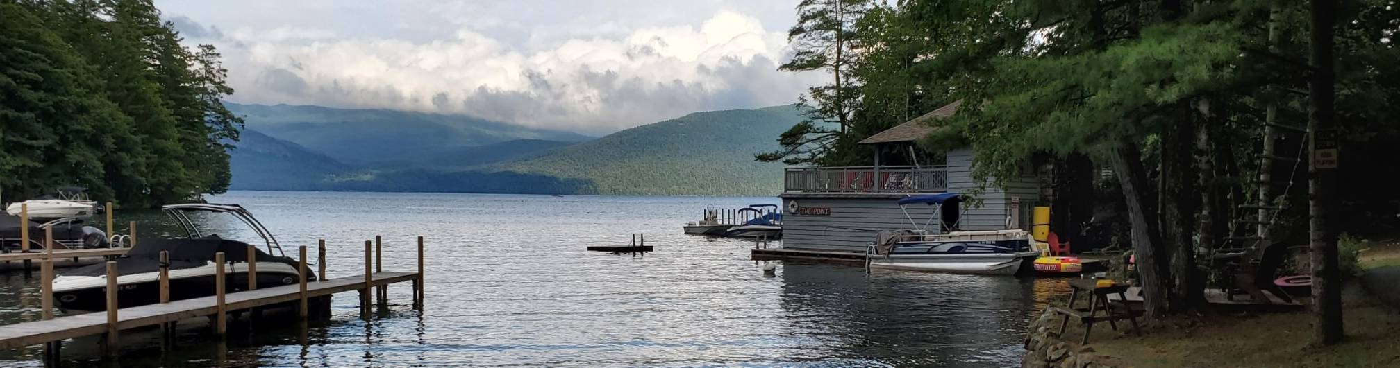 View of the lake, boathouse, boatramp, boats, and swim area a the point, bolton landing.